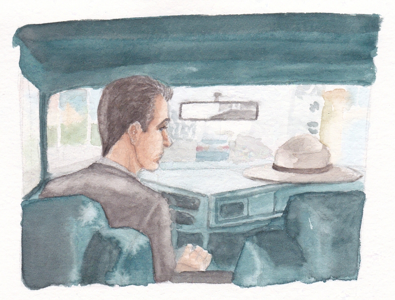 man in a car considering a hat